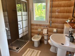 a bathroom with a sink and a toilet and a shower at Patty House in Colico +12 photos