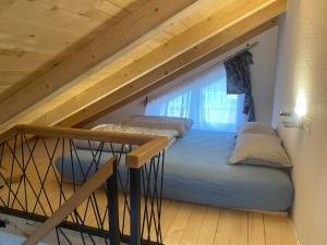 a couple of beds in a loft with a window at Dutaka Boutique Villa with Pool in Polje Ostružnica +13 photos
