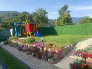 a garden with a playground and some flowers at Dutaka Boutique Villa with Pool in Polje Ostružnica