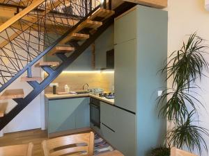 a kitchen with a staircase leading up to a loft at Dutaka Boutique Villa with Pool in Polje Ostružnica