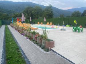 a swimming pool with a playground and a swimming pool at Dutaka Boutique Villa with Pool in Polje Ostružnica