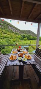 a table with many plates of food on it at Camp Sunny Hills in Virpazar +50 photos