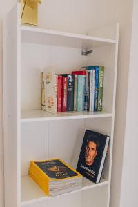 a book shelf with books on it with books at Apartment ZARJA in Dobrnič
