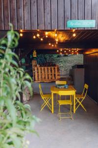 a yellow table and chairs on a patio with lights at Apartment ZARJA in Dobrnič +23 photos
