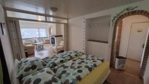 a bedroom with a bed and a living room at Appartamenti Villa Colibri in Neggio