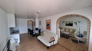 a living room with a couch and a table at Appartamenti Villa Colibri in Neggio