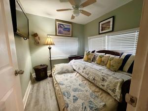 a bedroom with a bed and a ceiling fan at Mango Beach House in Lake Worth +21 photos