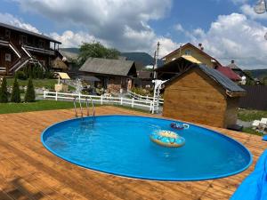 a swimming pool in a yard with a house at Welcome to Карпати in Skole