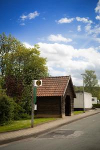 a small building on the side of a road at Reload Apartments - FeWo1 im Remmeker Feld in Bad Arolsen +21 photos
