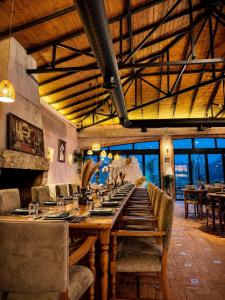 a long dining room with a long table and chairs at Mugull Agrotourism Hotel in Tirana