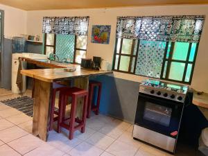 a kitchen with a wooden table and a stove at Franky's Fare in Fare