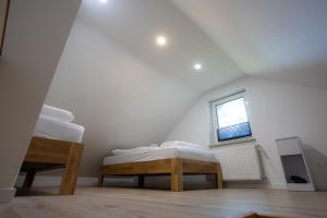 a white room with a bed and a window at Reload Apartments - FeWo1 im Remmeker Feld in Bad Arolsen