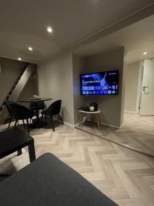 a living room with a large flat screen tv on a wall at Halden downtown apartment in Halden