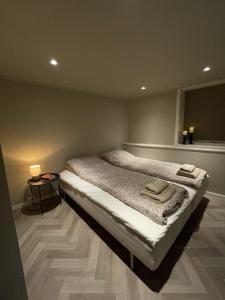 a bedroom with a bed with two towels on it at Halden downtown apartment in Halden