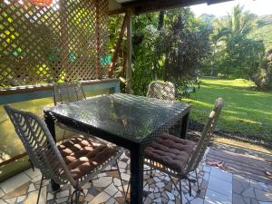a black table and chairs on a patio at Franky's Fare in Fare