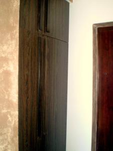 a wooden cabinet in the corner of a room at Apartment Zuric in Kolašin