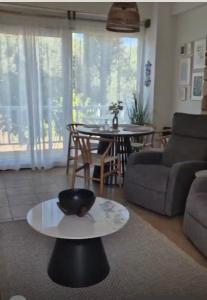 a living room with a table and a couch at Myrtos Olive Seaside Villa in Myrtos