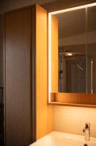 a bathroom with a mirror and a sink at Sigurstapi, Borgarfjörður Eystri in Borgarfjörður Eystri +26 photos
