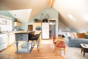 a kitchen and living room with a couch and a table at Bluebird Day - Pine Hideaway in Bend