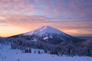 a snow covered mountain in the distance with a sunset at Bluebird Day - Pine Hideaway in Bend