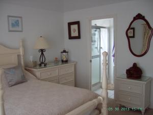 a bedroom with a bed with a mirror and a dresser at casaconejo 2 in Leeward