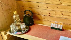 a table with a tea kettle and glasses on it at Chatka in Tappernøje +16 photos
