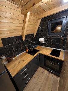a small kitchen with a sink and a stove at Vikendica Ema in Šipovo