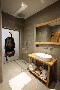 a bathroom with a sink and a shower at Mugull Agrotourism Hotel in Tirana +49 photos