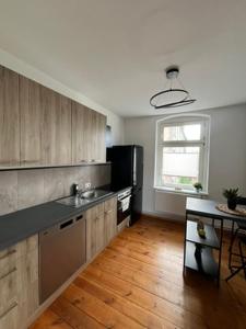 a kitchen with a sink and a refrigerator at Cityapartment Rosi in Pasewalk