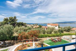 a view from the balcony of a house with a garden at Fiore Di Mare Studios in Lassi