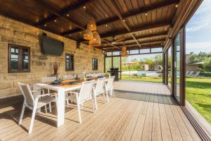 a patio with a table and chairs on a deck at New to the market - 4BR Farmhouse with Pool by SF Homes in Siġġiewi +71 photos