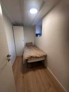 a small bedroom with a bed in a room at Abildsø Apartment in Oslo