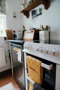 a kitchen with a white stove top oven at Little Woodacott in Barnstaple