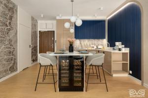 a kitchen with a table and some chairs and a counter at Apartament POGO LOVERS in Pogorzelica