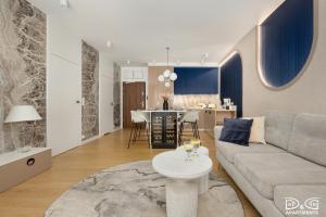 a living room with a couch and a table at Apartament POGO LOVERS in Pogorzelica