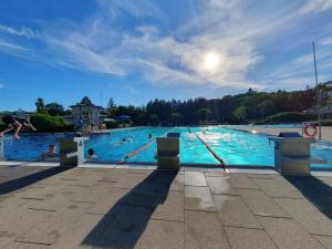 a large swimming pool with people in the water at FeWo Altstadt Herrieden in Herrieden