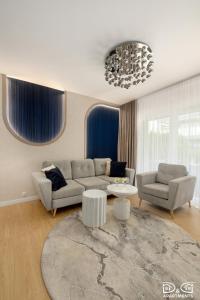 a living room with a couch and a table at Apartament POGO LOVERS in Pogorzelica +84 photos