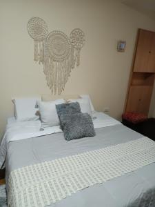 a white bed with two pillows on top of it at Refugio Quilmes Centro - Work & Relax in Quilmes