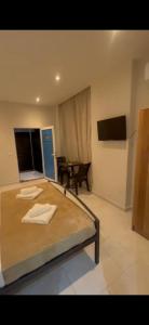 a large bed in a room with a table at Helgis Center in Himare
