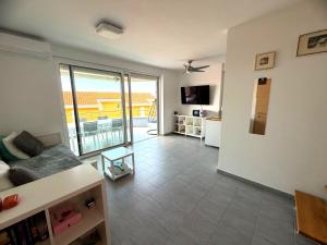 a living room with a couch and a balcony at Anai Jadranovo Sea View Penthouse in Jadranovo