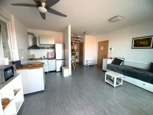 a living room with a couch and a kitchen at Anai Jadranovo Sea View Penthouse in Jadranovo