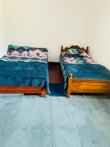 two beds sitting next to each other in a room at Chill Bill Holiday inn in Haputale