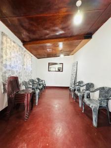 an empty room with chairs and tables and a ceiling at Chill Bill Holiday inn in Haputale