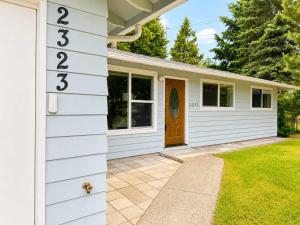 a white house with a door and a yard at Bellevue Pet friendly Home Fenced Yard in Bellevue