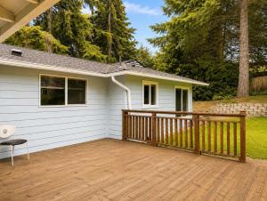 a house with a wooden deck next to a house at Bellevue Pet friendly Home Fenced Yard in Bellevue