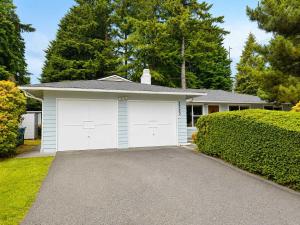 a garage with white doors on a house at Bellevue Pet friendly Home Fenced Yard in Bellevue +24 photos