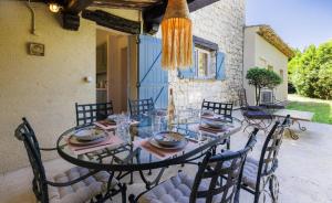 a dining room table with chairs and a chandelier at villa la Sine in Vence