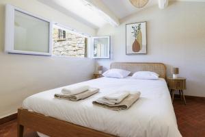 a bedroom with a white bed with towels on it at villa la Sine in Vence +44 photos