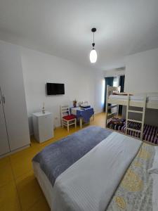 a bedroom with a large bed and a tv at Hotel Restorant Genti Peshkatari in Orikum