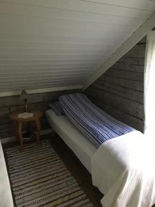 a bed in a attic room with a table at Senja, Villa View in Senja